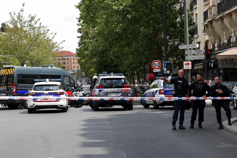 Police and vehicles block a street near the Porte de Clichy in Paris after a knife attack