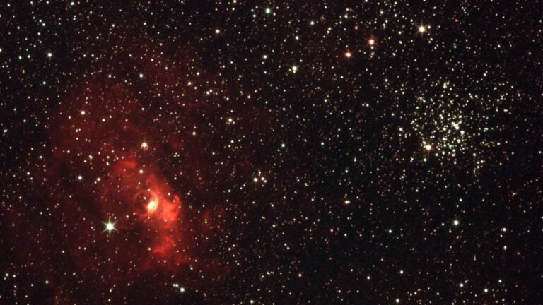 A red nebula and dense star field representing the stellar neighbourhood of the GJ 887 planetary system