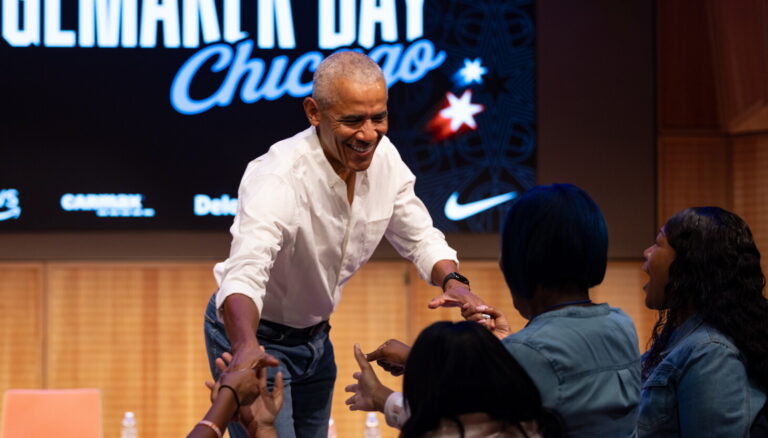 Former President Barack Obama surprises a group of ninth grade girls Friday during the WNBA Changemaker Day at the Obama