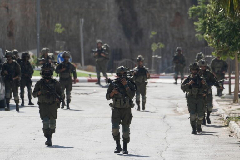 Israeli army soldiers patrol the streets of the occupied West Bank village of Qusra, south of Nablus, Thursday, Aug. 13
