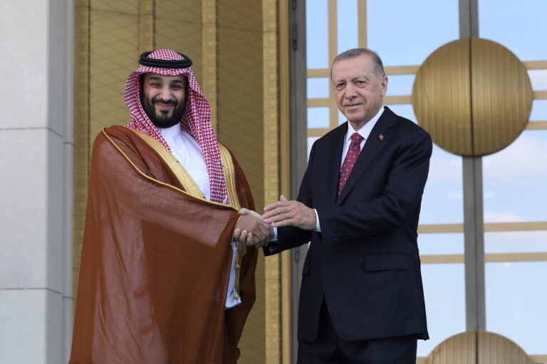 Turkish President Recep Tayyip Erdogan, right, and Saudi Crown Prince Mohammed bin Salman shake hands during a welcome