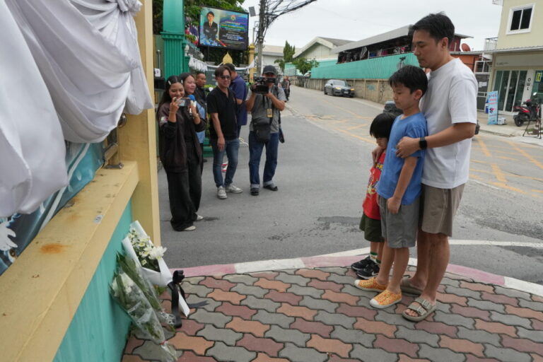People offer prayers at the gate of Debsirin Nonthaburi School, a day after the shooting at the school in Nonthaburi