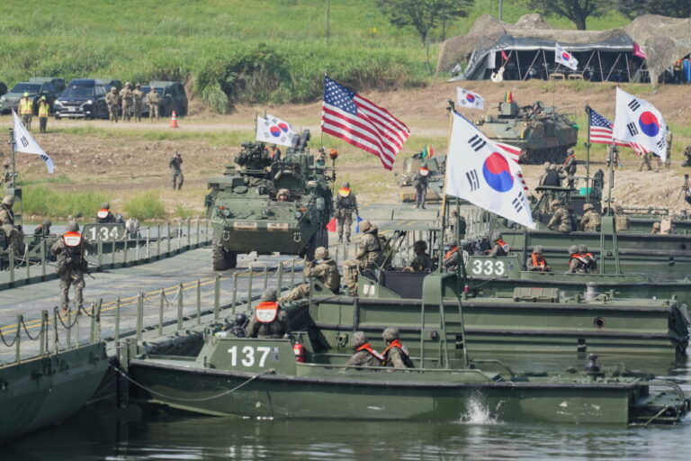 A vehicle from U.S. Army's the Stryker Combat Team crosses a floating bridge on the Namhan River during the combined