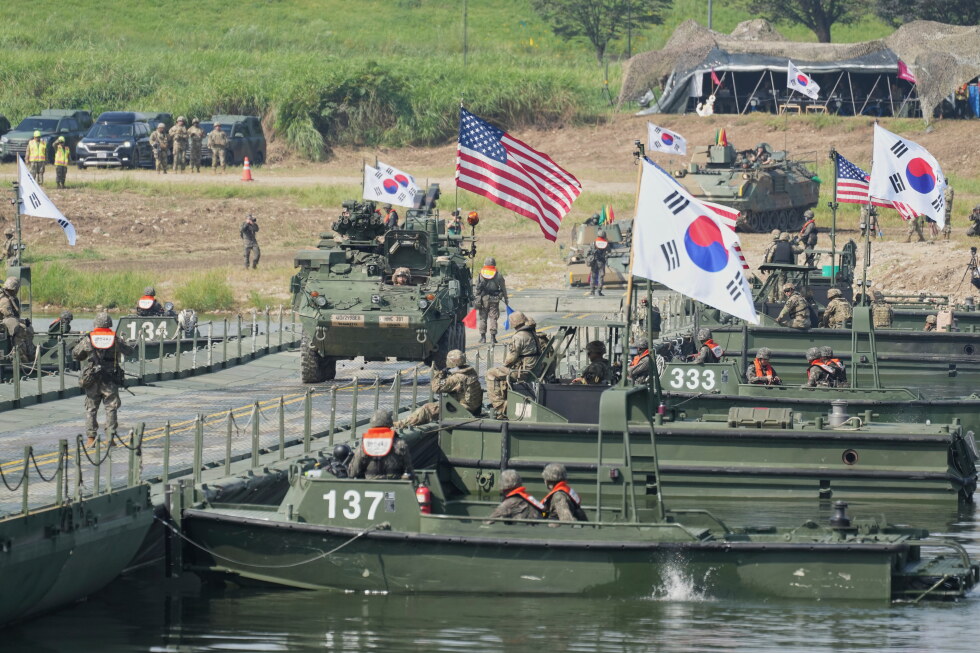 A vehicle from U.S. Army's the Stryker Combat Team crosses a floating bridge on the Namhan River during the combined