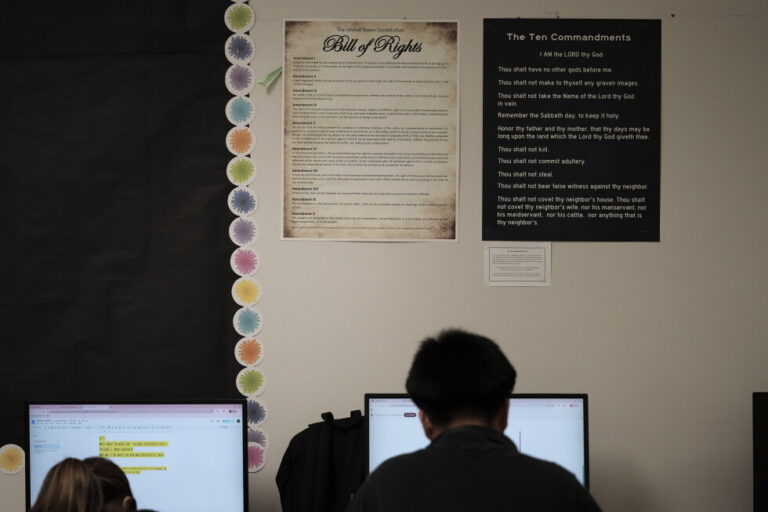 Students work under Ten Commandments and Bill of Rights posters on display in a classroom at Lehman High School in Kyle