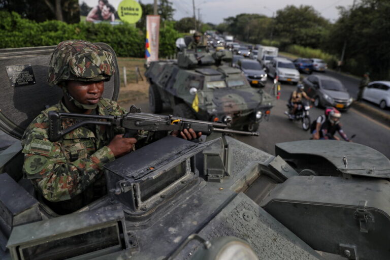 A soldier keeps watch from the turret of an armored vehicle ahead of the inauguration of President-elect Abelardo de la
