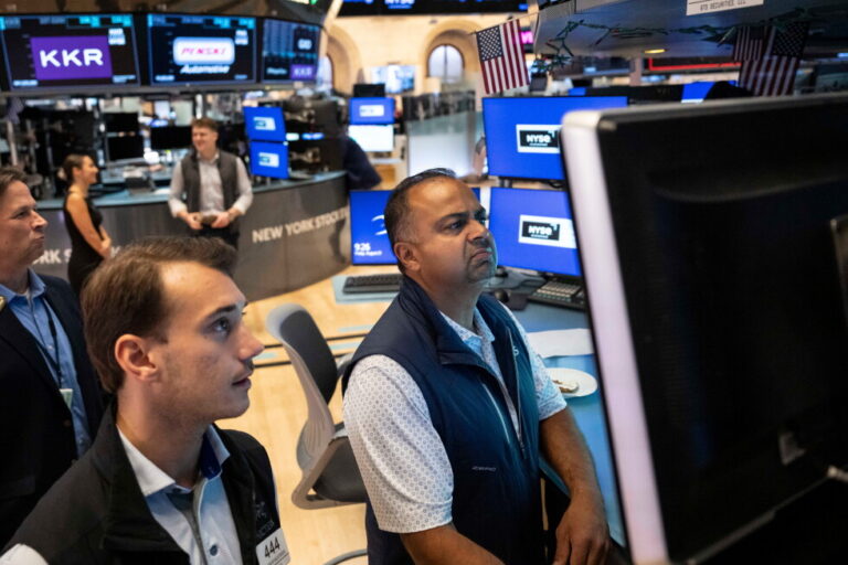 Specialists Dilip Patel, right, and Dylan Halvorsen work on the floor of the New York Stock Exchange in New York, Friday