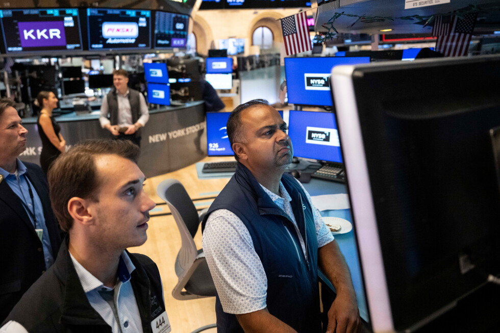 Specialists Dilip Patel, right, and Dylan Halvorsen work on the floor of the New York Stock Exchange in New York, Friday