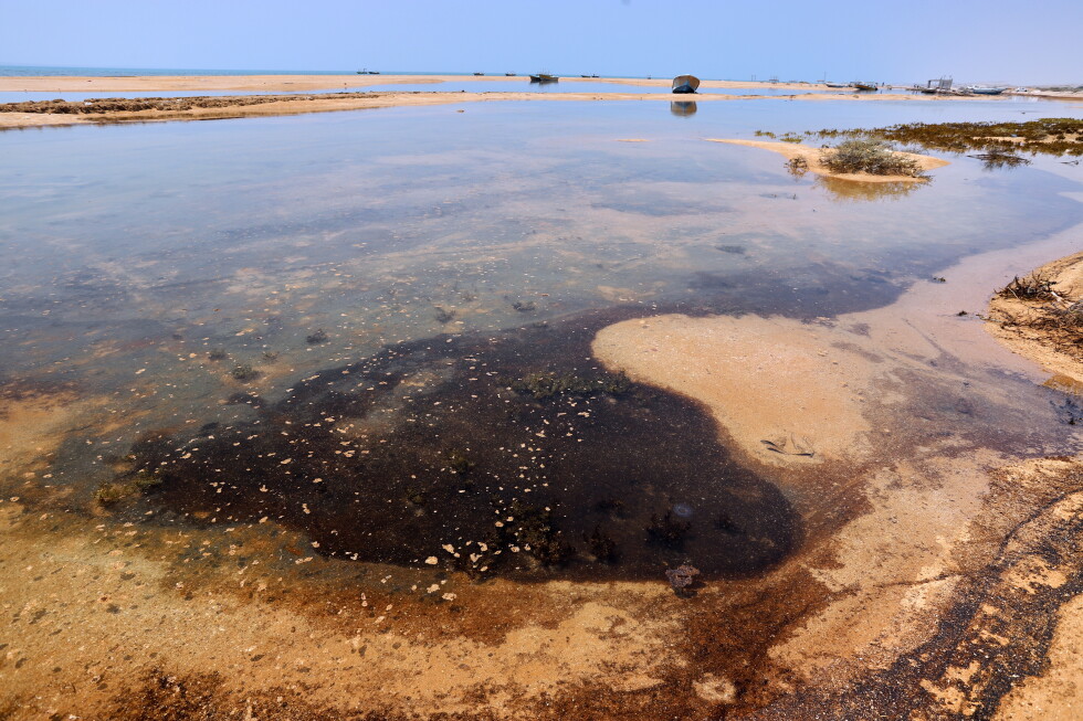 Dark oil residue collects in shallow coastal waters on Qeshm Island, Iran, Thursday, Aug. 13, 2026, amid ongoing wartime