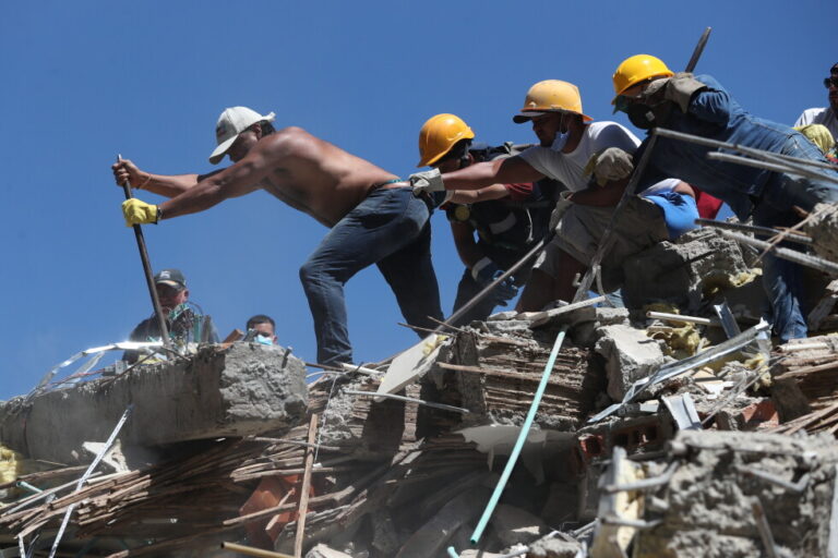 Residents and rescue workers search through the rubble after an earthquake struck Cali, Colombia, Monday, Aug. 10, 2026. (AP