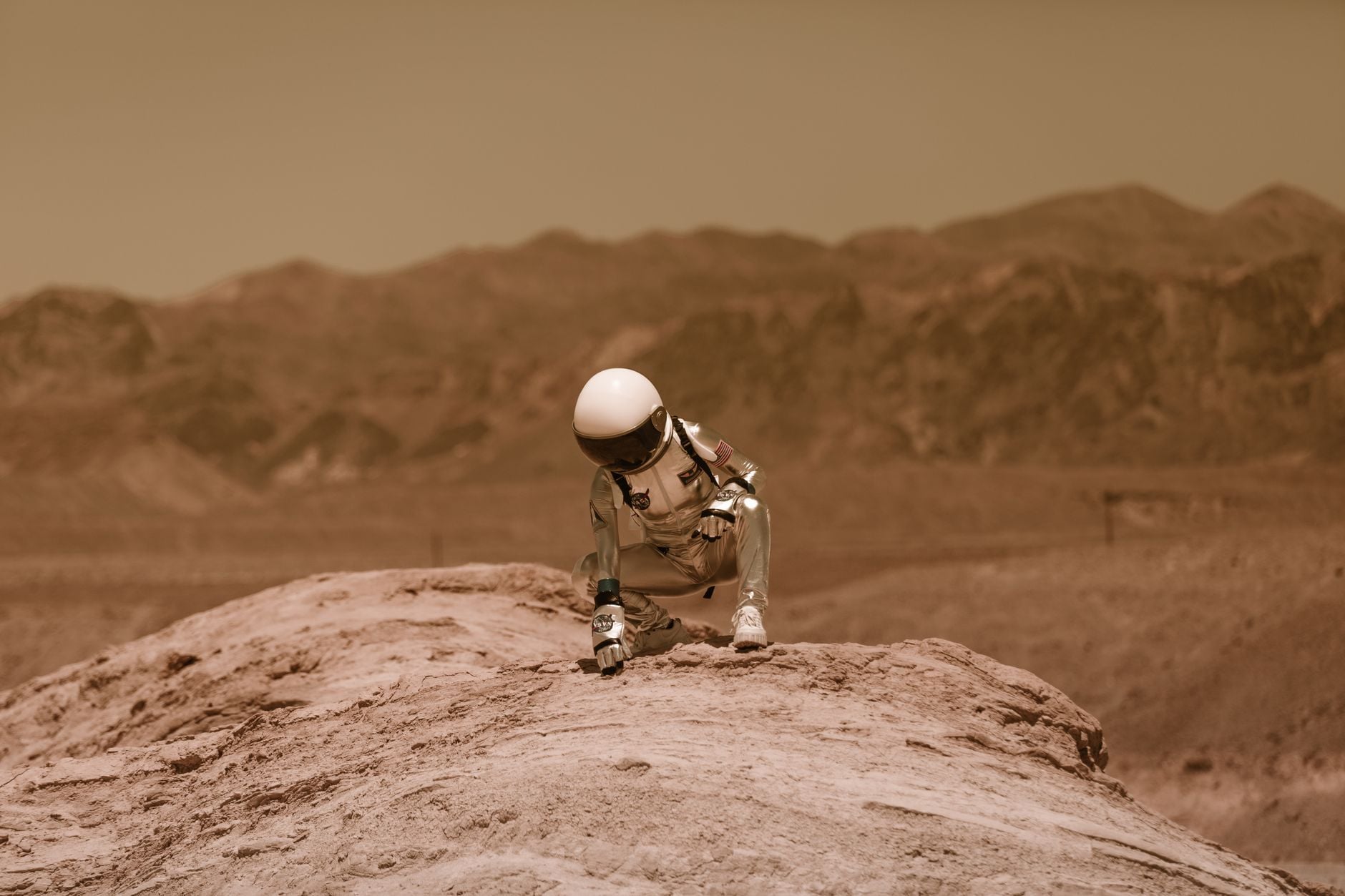 Representative staged image of an astronaut in a red desert landscape on Earth