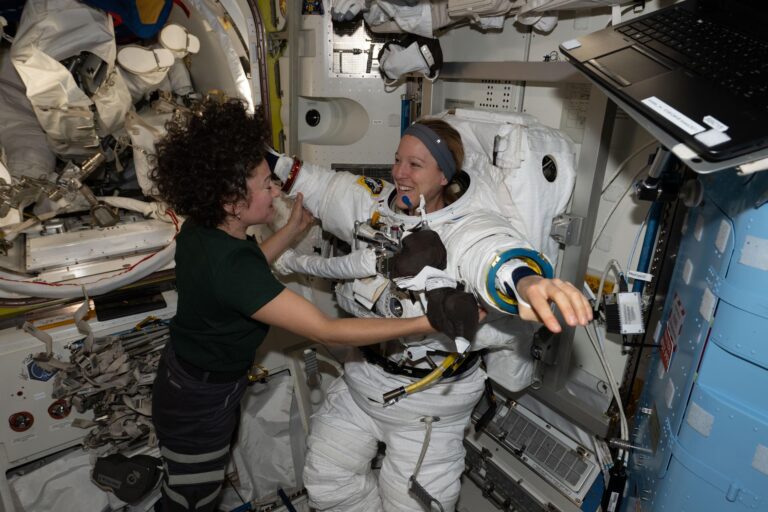 Expedition 74 flight engineers Sophie Adenot of ESA (European Space Agency) and Jessica Meir of NASA work together inside