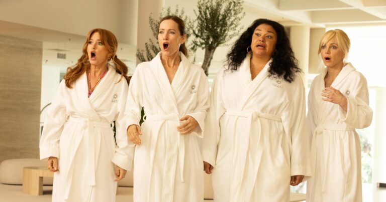 Four women in white robes are shocked at a spa