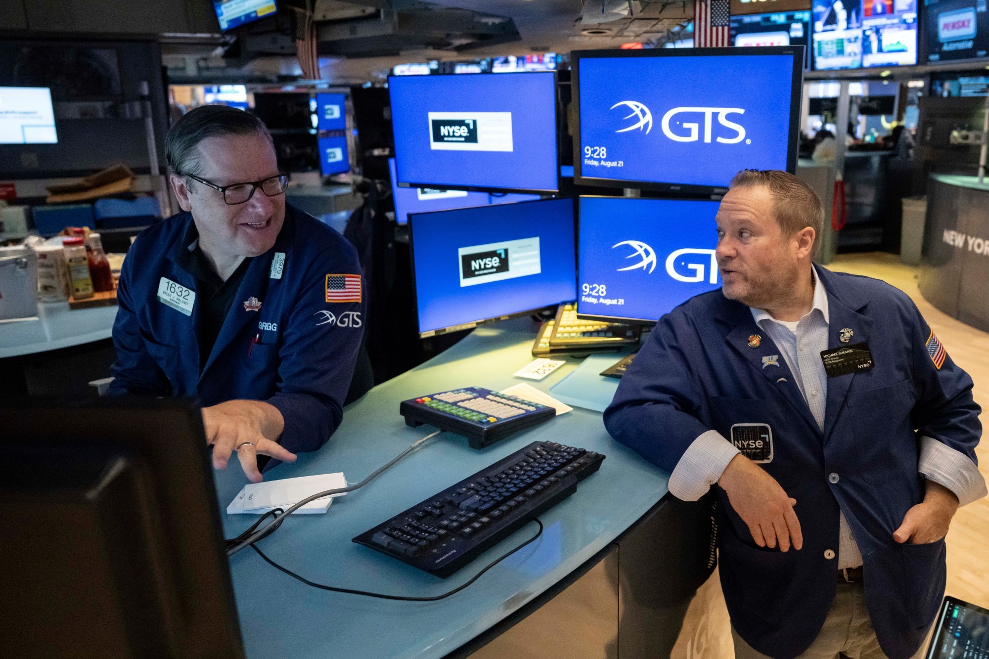 Specialists Gregg Maloney and Michael Shearin work on the floor of the New York Stock Exchange