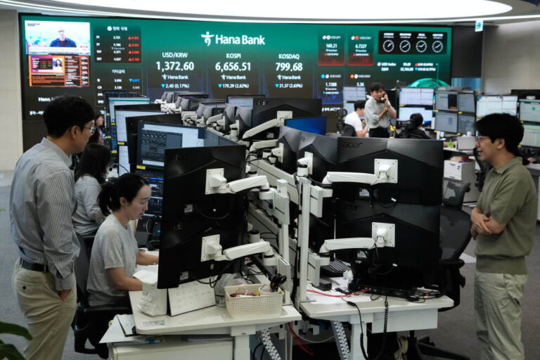 Currency traders work at the foreign exchange dealing room of the Hana Bank headquarters in Seoul, South Korea, Wednesday
