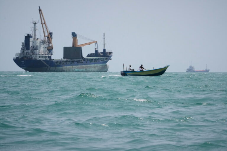 A motorboat passes a general cargo ship anchored in the Strait of Hormuz off Bandar Abbas, Iran, Sunday, Sept. 6, 2026. (AP