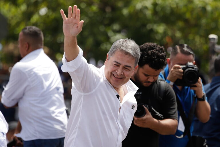 Former Honduran President Juan Orlando Hernández waves after his arrival to Toncontin airport in Tagucigalpa, Honduras