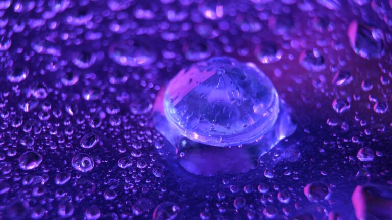 A close up of a diamond against a purple surface