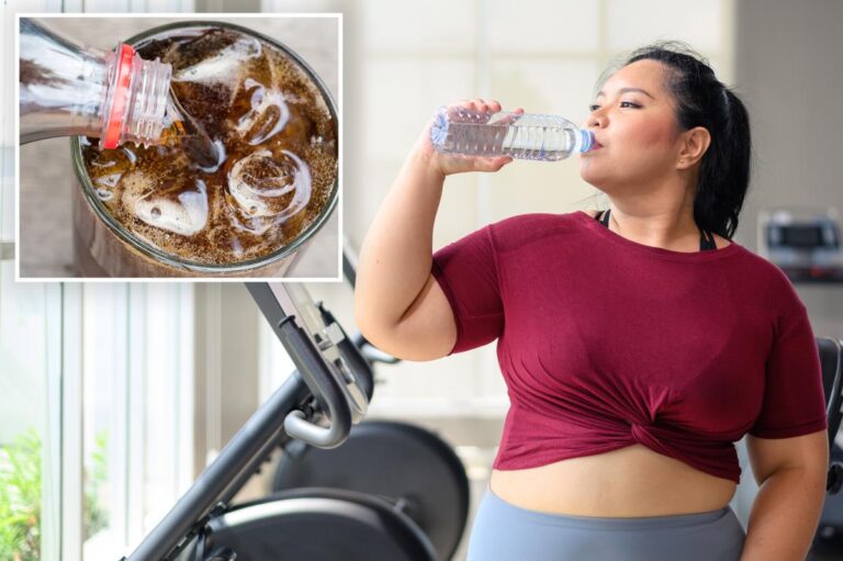 An overweight young woman is pictured drinking water from a bottle after a fitness training workout in a gym, with an