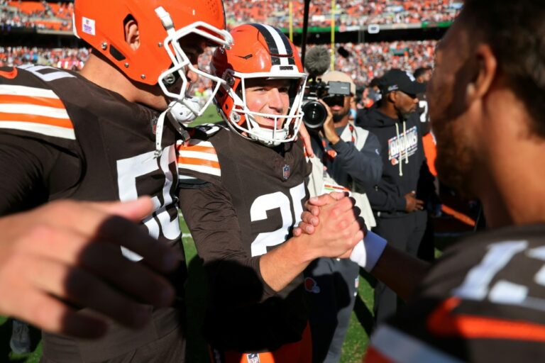 Cleveland kicker Andre Szmyt, center, celebrates with teammates after hitting the winning field goal on the final play to