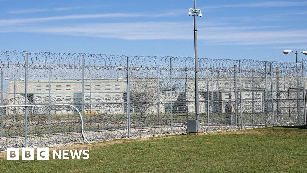A fence, barbed wire and a guard are visible at the Allan B. Polunsky Unit, the prison that houses the men on Texas' death