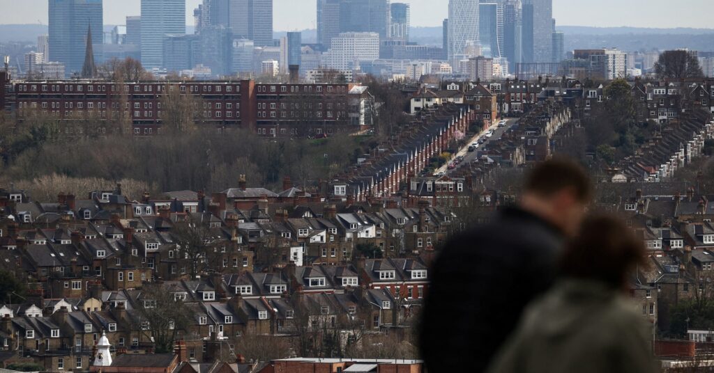 Rows of houses lie in front of the Canary Wharf skyline in London, Britain, March 19, 2023. REUTERS/Henry Nicholls/File Photo
