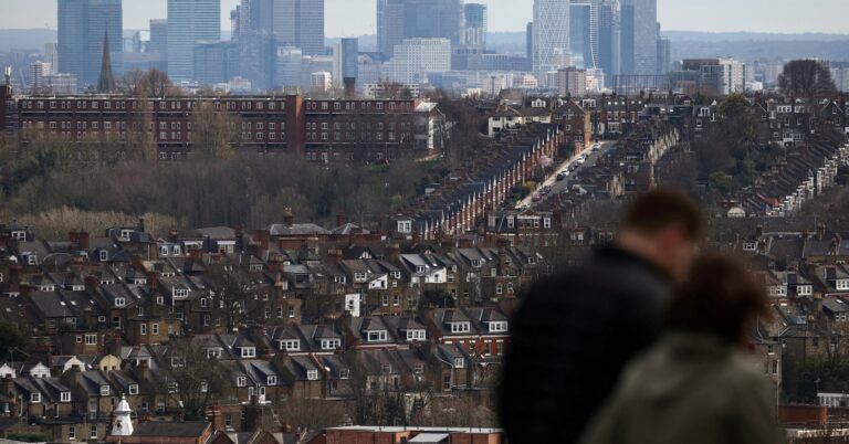 Rows of houses lie in front of the Canary Wharf skyline in London, Britain, March 19, 2023. REUTERS/Henry Nicholls/File Photo