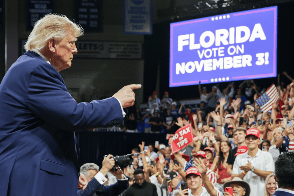 U.S. President Donald Trump points to the crowd as he departs following an election rally at Alico Arena on the Florida Gulf