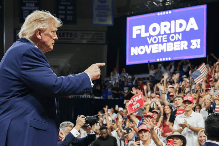 U.S. President Donald Trump points to the crowd as he departs following an election rally at Alico Arena on the Florida Gulf