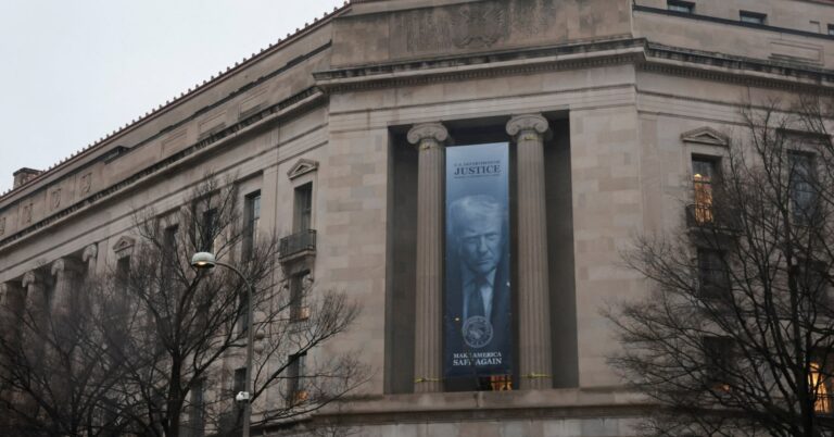 A new banner depicting U.S. President Donald Trump hangs from the Department of Justice building in Washington, D.C., U.S