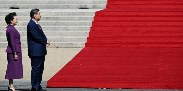 China's President Xi Jinping and his wife Peng Liyuan stand together as they arrive with US President Donald Trump and First