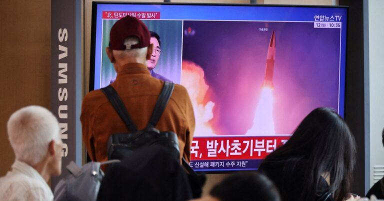 People watch a TV broadcasting a news report on North Korea firing multiple ballistic missiles toward the sea off its east