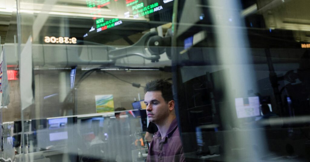 A futures-options trader works on the floor at the New York Stock Exchange (NYSE) in New York City, U.S., August 21, 2026