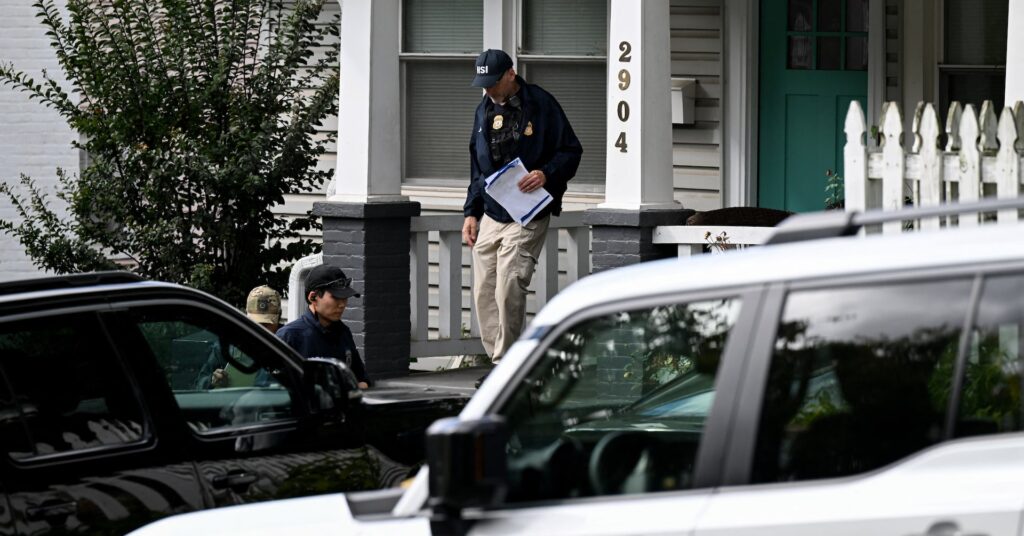Agents of the Homeland Security Investigations (HSI) work at the entrance of the residence of US Rep. Ilhan Omar (D-MN)