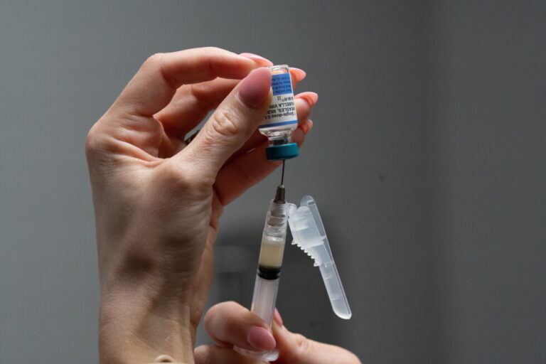 A nurse, prepares a combination measles, mumps and rubella vaccine for a patient at a pediatrics clinic in Easley, S.C