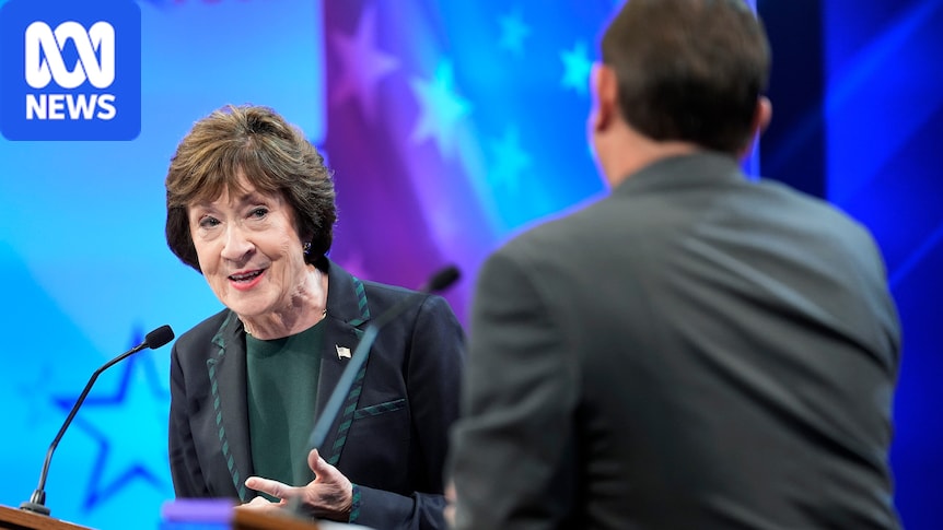 Susan Collins stands behind a debate podium and looks toward Troy Jackson