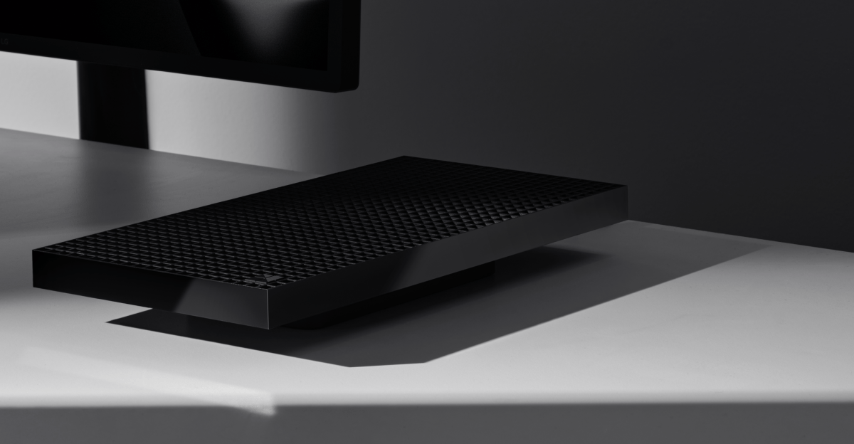 A Microsoft Surface RTX Spark Dev Box on a desk by a monitor